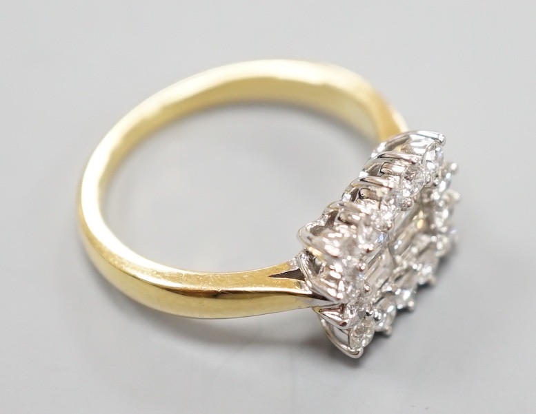 A 750 yellow metal, baguette and round cut diamond set rectangular cluster ring, size M, gross weight 4.8 grams.